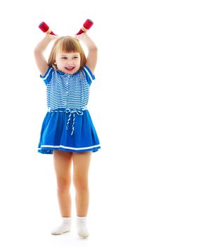 A cute little girl doing exercises with dumbbells. The concept of strength, health and sport. Isolated on white background.