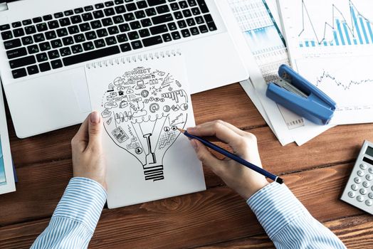 close-up, woman draws business notes in her notebook. Business Innovation Concept