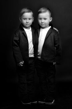 two little boys dressed in tuxedo. Isolated on white background