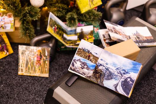 photobook, album and weights for sports near the Christmas tree as a gift holiday