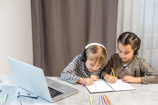 Portrait of two person nice-looking attractive charming cute lovely positive funny cheerful cheery girls researching subject browsing doing homework in light white interior class room indoors