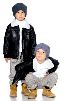 Studio portrait of boys in black leather jackets.Isolated on white background.