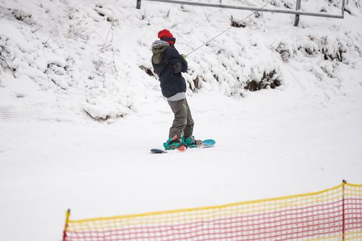 Tourists enjoy to play ski and snowboard at ski resort on holiday.