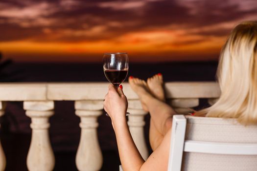 A woman holding a glass of wine. High quality photo
