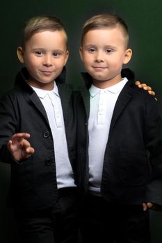 two little boys dressed in tuxedo. Isolated on white background