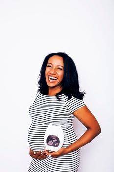 young pretty african american woman pregnant happy smiling, posing on white background isolated , lifestyle people concept copyspace close up