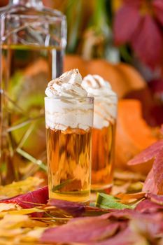 Two vodka with cream cinnamon pumpkin pie shooters in shot glasses. These drinks are easy to make and perfect for fall. Try these boozy drinks at your Halloween or Thanksgiving party