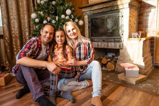 family and christmas tree in an old wooden house