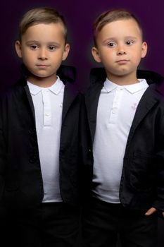 two little boys dressed in tuxedo. Isolated on white background