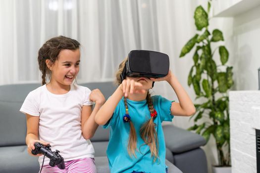 two little girls playing video games virtual reality glasses