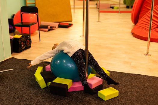closeup of little gymnast girl doing exercises