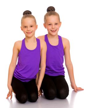 Girls gymnasts perform exercises. The concept of strength, health and sport. Isolated on white background.