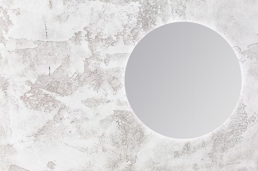 round mirror on gray background