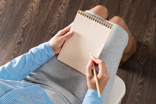 close-up a female hands with notebook and pencil