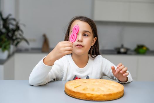 Girl in the birthday with a cake with candle