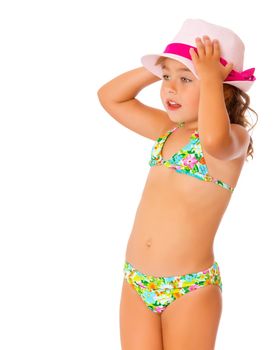 Beautiful little tanned girl in a swimsuit and a hat. The concept of summer family vacations, rest on the sea, beautiful tan. Isolated on white background.
