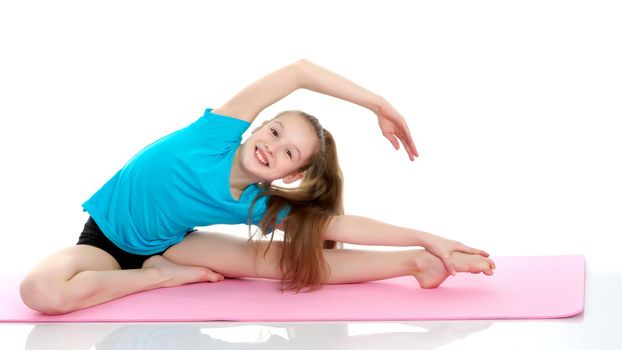 Girl gymnast performs an acrobatic element on the floor.The concept of childhood, sport, a healthy lifestyle, physical development of personality. Isolated on white background.
