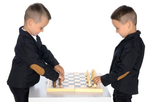 Two brothers are playing chess at home. Game, education, lifestyle concept.Isolated on white background