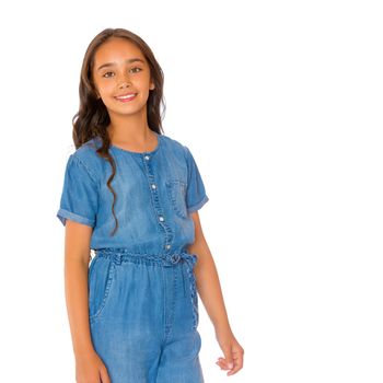 Portrait of a beautiful asian teenage girl with long black hair, in denim overalls. The concept of advertising a healthy lifestyle, beauty and fashion. Isolated on white background.