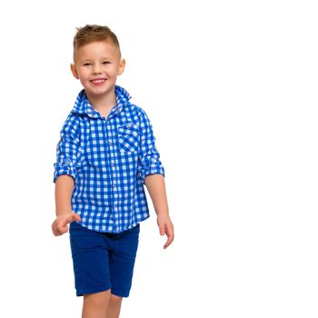 A cute little boy in a shirt and shorts. The concept of a summer family vacation, a happy childhood. Isolated on white background.