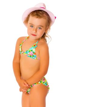 Beautiful little tanned girl in a swimsuit and a hat. The concept of summer family vacations, rest on the sea, beautiful tan. Isolated on white background.