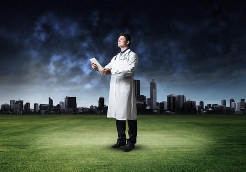 portrait of a doctor, holding a tablet
