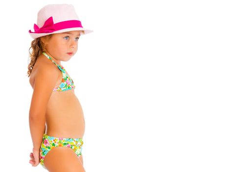 Beautiful little tanned girl in a swimsuit and a hat. The concept of summer family vacations, rest on the sea, beautiful tan. Isolated on white background.