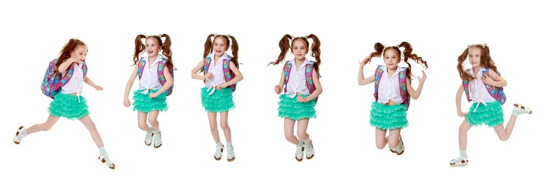 A cheerful little girl hurries to school. The concept of education, children's emotions. Isolated on white background.