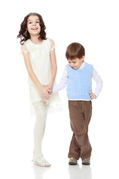 Beautiful little girl in a white dress holds the hand of his younger brother.Isolated on white background.