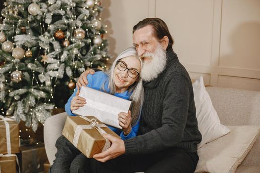 Age and people concept . Senior couple at home. Woman in a blue sweater.