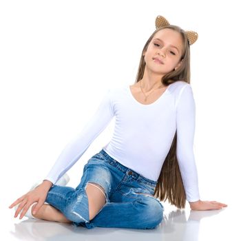 Beautiful teen girl in jeans with holes. Concept of happy childhood, fashion and style. Isolated on white background.