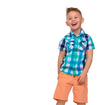 A cute little boy in a shirt and shorts. The concept of a summer family vacation, a happy childhood. Isolated on white background.