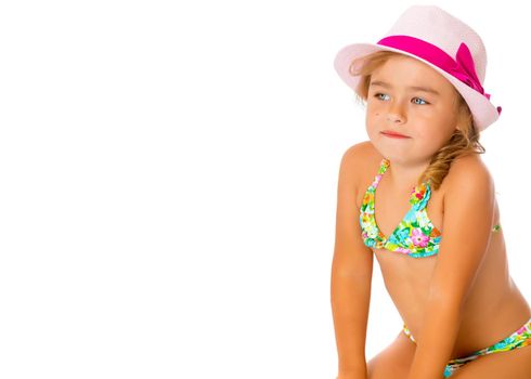 Beautiful little tanned girl in a swimsuit and a hat. The concept of summer family vacations, rest on the sea, beautiful tan. Isolated on white background.