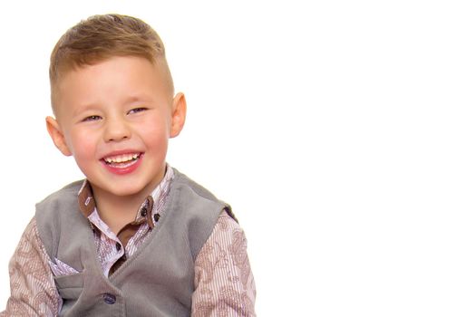 A beautiful little boy laughs fun. The concept of a happy childhood, well-being and family values. Isolated on white background.