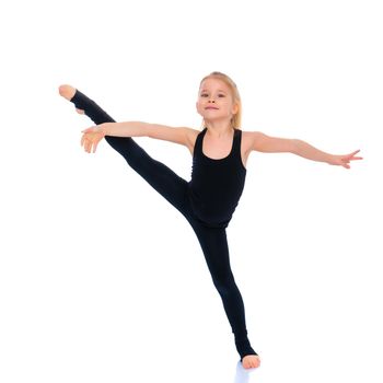 A girl gymnast balances on one leg.The concept of childhood, sport, a healthy lifestyle. Isolated on white background.