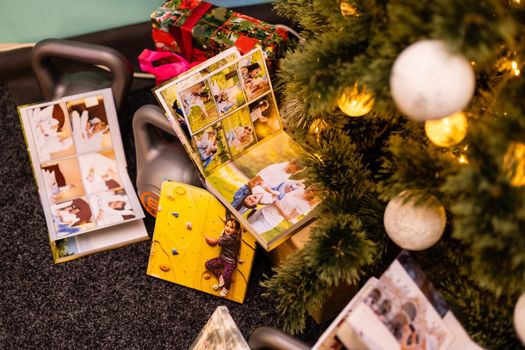 photobook, album and weights for sports near the Christmas tree as a gift holiday