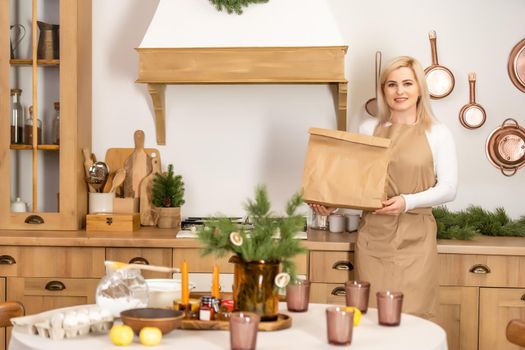 Young beautiful woman holding take away paper bag from delivery