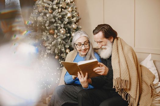 Age and people concept . Senior couple at home. People with book.