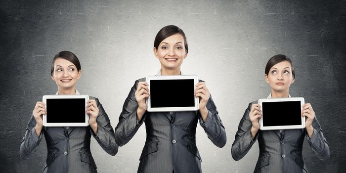 Women stand in a row. demonstrate computer tablets with cope space.