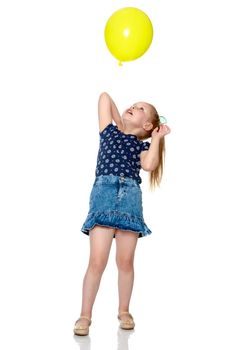 Little girl is playing with a balloon. The concept of the holiday, birthday. Isolated over white background