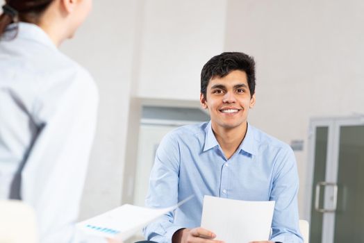 portrait of a young man at a business meeting. concept of team work