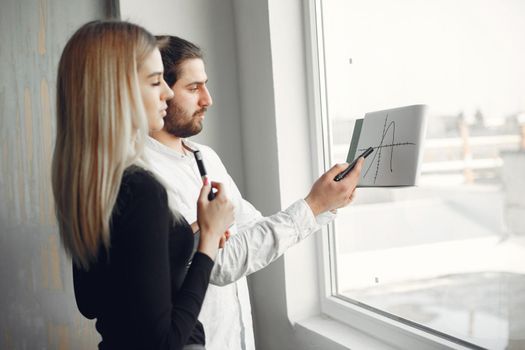 Handsome man in a white shirt. Partners together. People by the window.