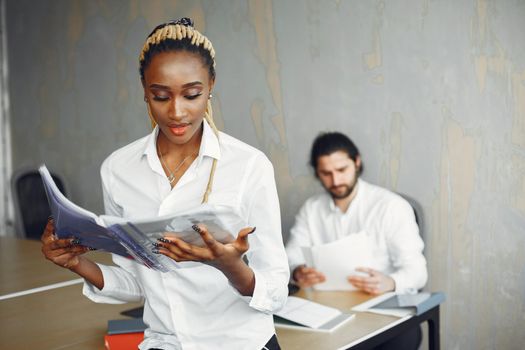 Handsome man in a white shirt. African woman with partner. Guy with a laptop.