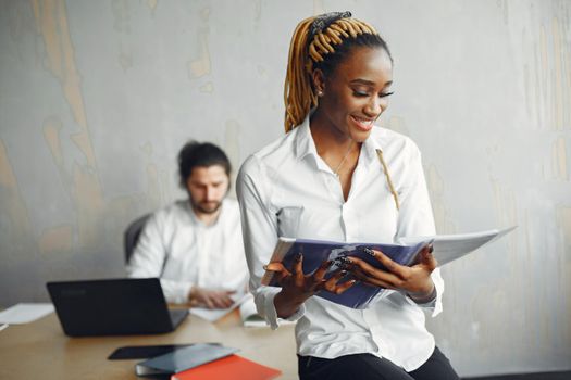 Handsome man in a white shirt. African woman with partner. Guy with a laptop.