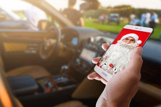 Christmas online congratulations. Surprised, shocked man wearing medical mask talking on the phone with friends and parents. christmas tree bokeh background