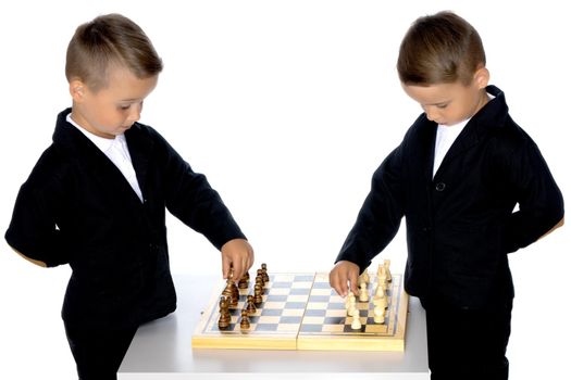 Two brothers are playing chess at home. Game, education, lifestyle concept.Isolated on white background