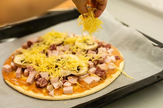 little girl makes pizza at home