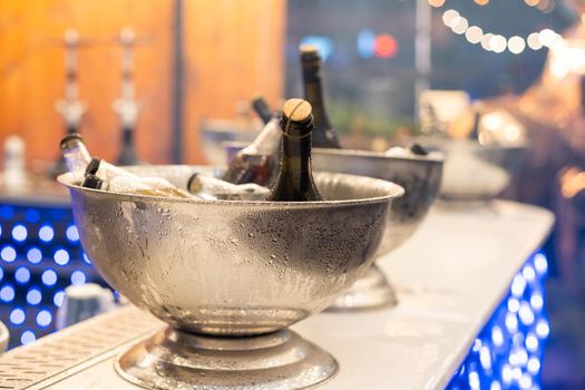 Wine bottles set in bucket, alcohol cooling