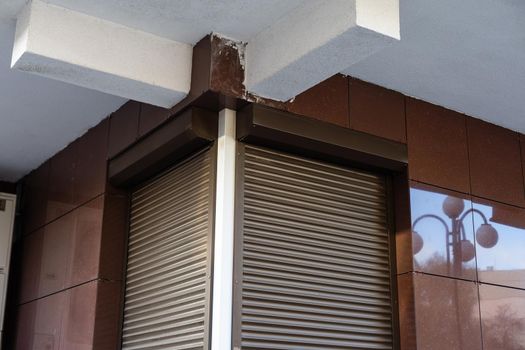 Window with modern shutter, exterior shot.