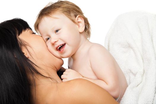 Young mother with her baby after bathing in a white towel